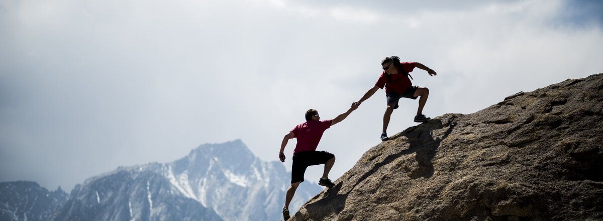 Bergsteiger helfen sich gegenseitig beim Aufstieg